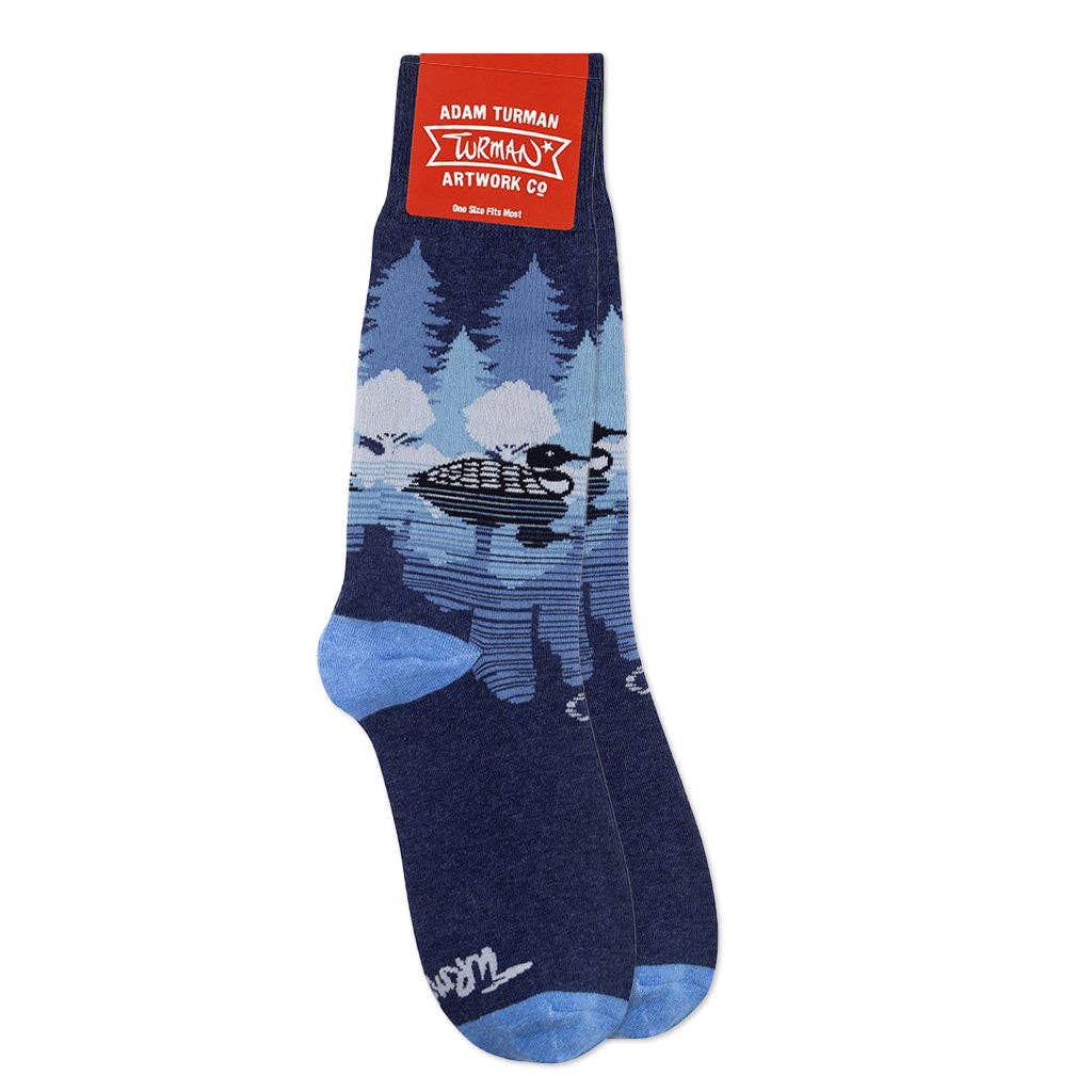 Introducing Adam Turmans Midnight Loon Socks: one-size blue socks featuring a loons silhouette on a tranquil lake, bordered by trees. Show your MN pride with this unique and comfortable design.