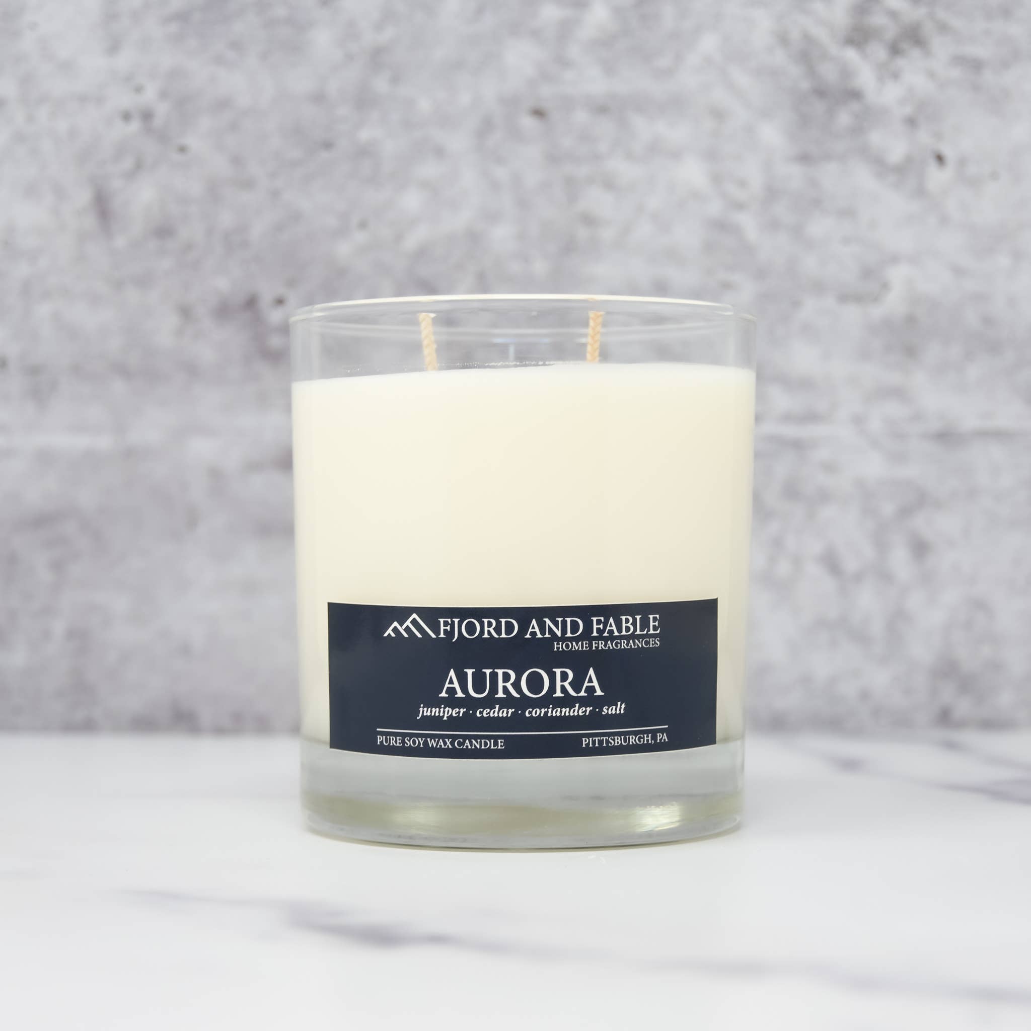 The Aurora Candle by Fjord & Fable is an 8oz Scandinavian-inspired soy wax candle in a glass jar with a 45+ hour burn time.