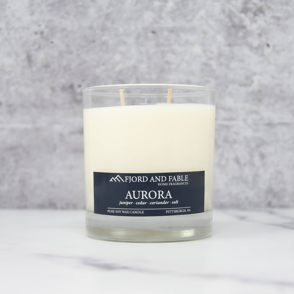 The Aurora Candle by Fjord & Fable is an 8oz Scandinavian-inspired soy wax candle in a glass jar with a 45+ hour burn time.