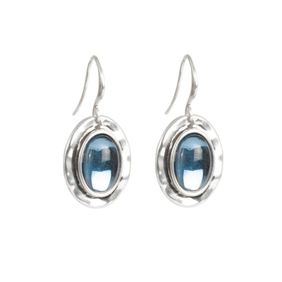 A&C Oslo Silver Deep Blue Hanging Earrings feature blue oval gemstones in raised bezels with simple hooks, inspired by modern Scandinavian design.