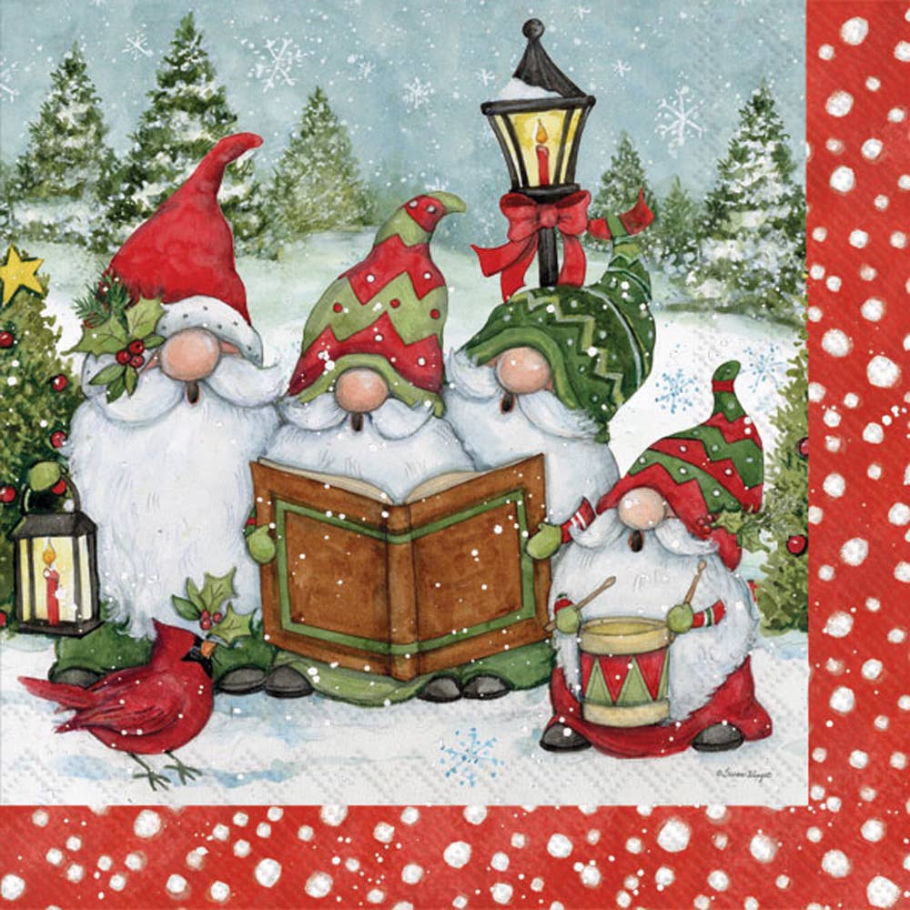 Four gnomes in festive hats stand in the snow—two with a book, one with a lantern, one with a drum—as a cardinal perches nearby. Celebrate with our Napkins: Gnome Carolers Christmas Cocktail Napkins 20 pkg.