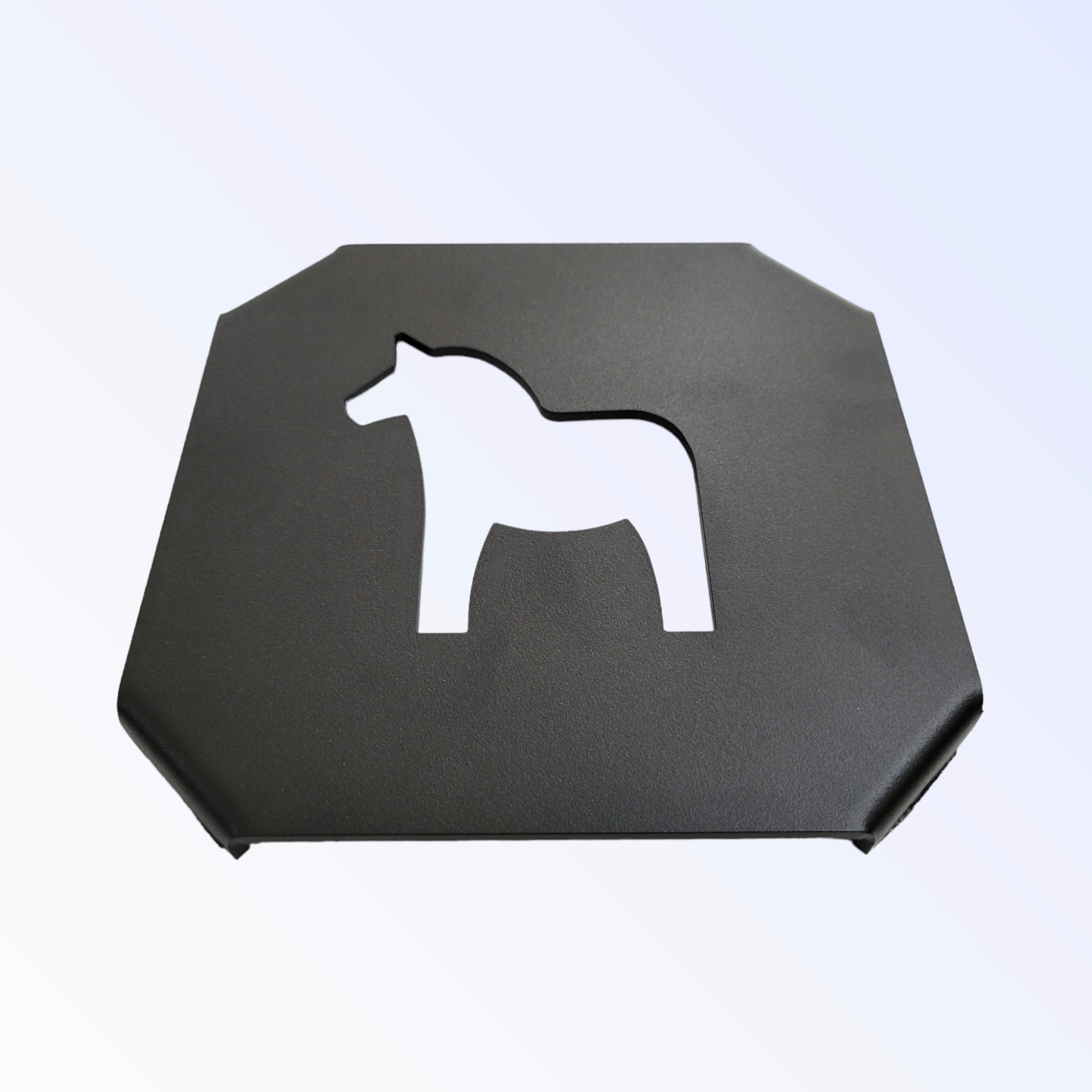 This black cast iron trivet, embossed with a Swedish Dala Horse cutout, showcases a timeless equine design.