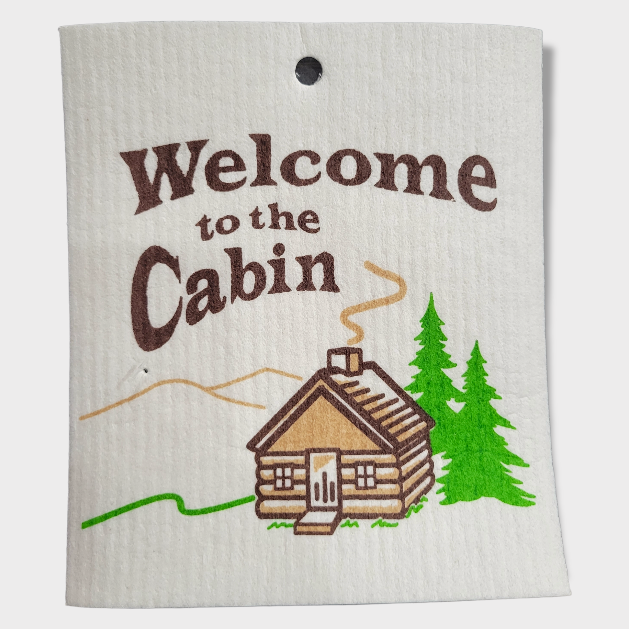 The Welcome to the Cabin Swedish Dish Cloth (6.6"x7.9") features a log cabin, two green trees, and a winding path—ideal for eco-conscious homes.