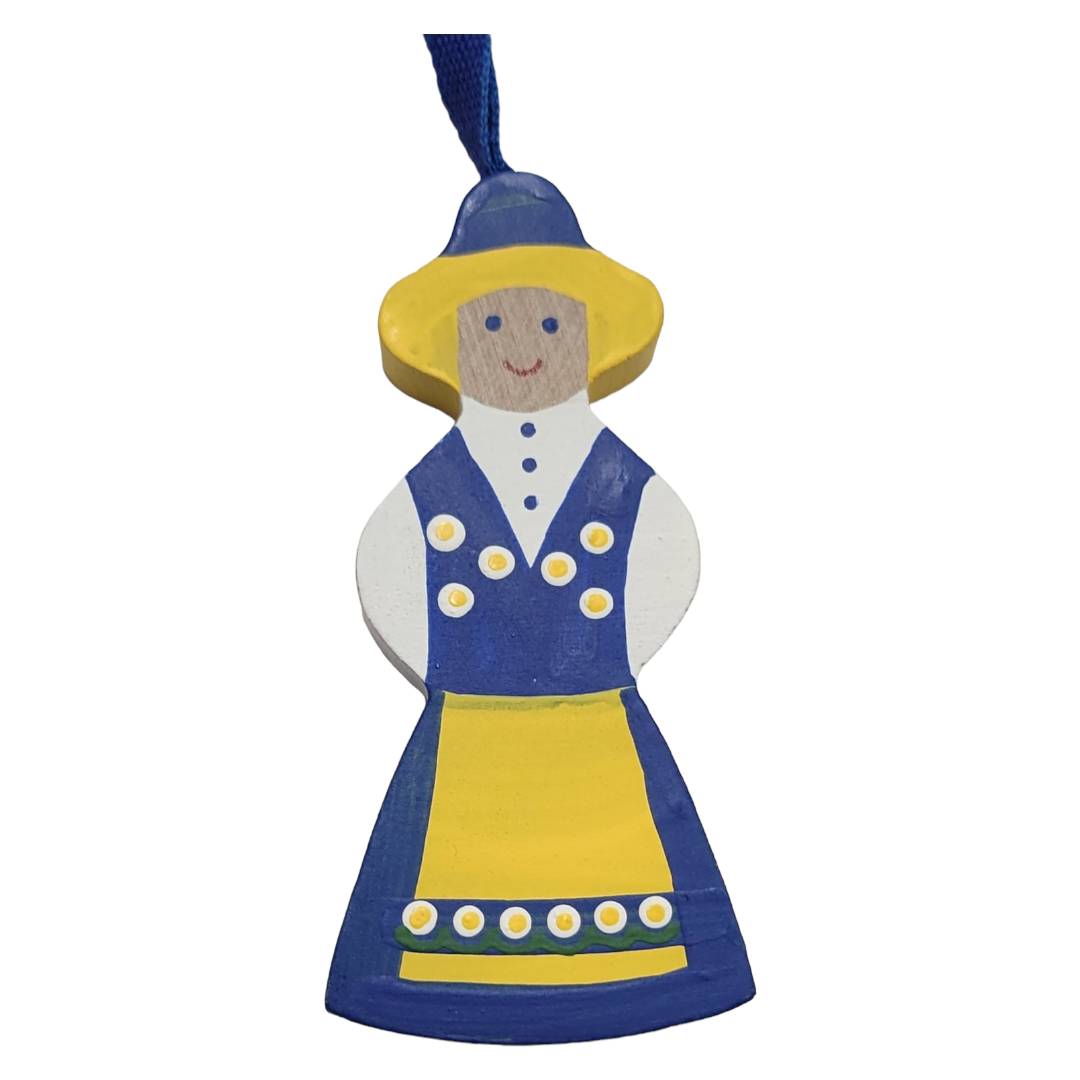 The Ornament: National Costume Swedish Girl showcases a delightful wooden figure of a person dressed in traditional attire, featuring a blue and yellow dress, a matching hat, and a cheerful expression, making it an ideal addition to bring festive charm to your holiday décor.