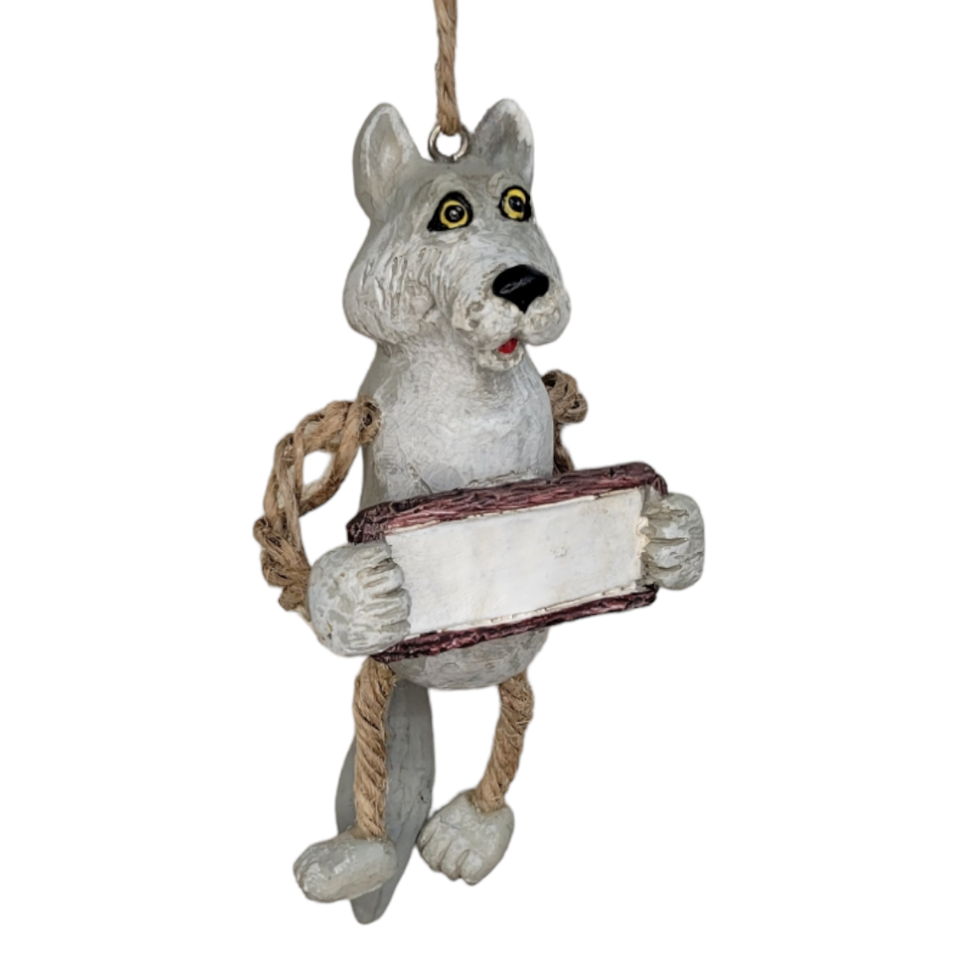 Introducing the "Ornament: Wolf w/Sign"—a charming figurine crafted from stone or clay that doubles as a delightful holiday décor piece. Featuring rope-like arms, this wolf grips a blank sign ideal for personalization.
