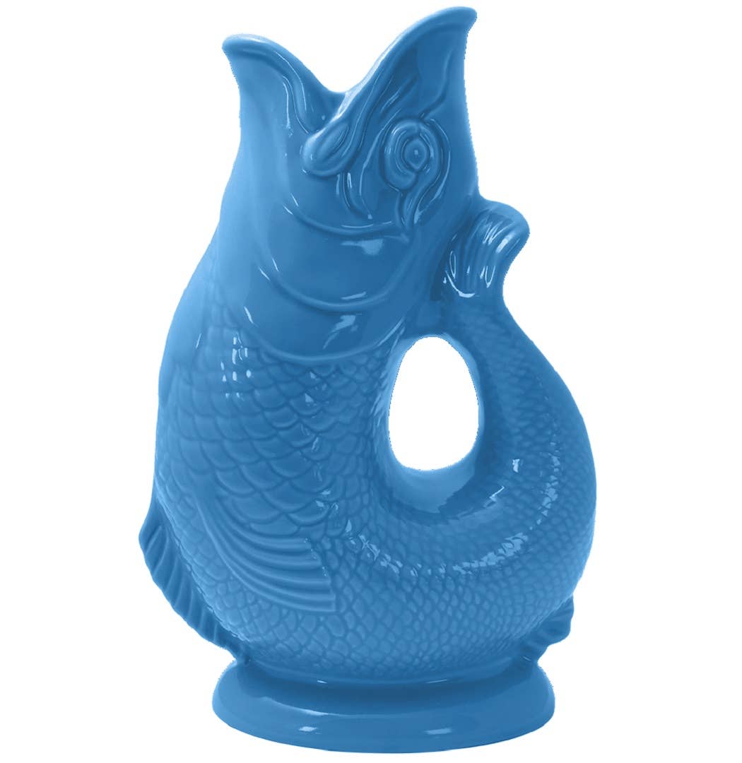 The Gluggle Jug: Sea Blue is a fish-shaped pitcher with an upright tail and open mouth, featuring a handle-like center opening—a functional, iconic jug that makes a gluggle sound.