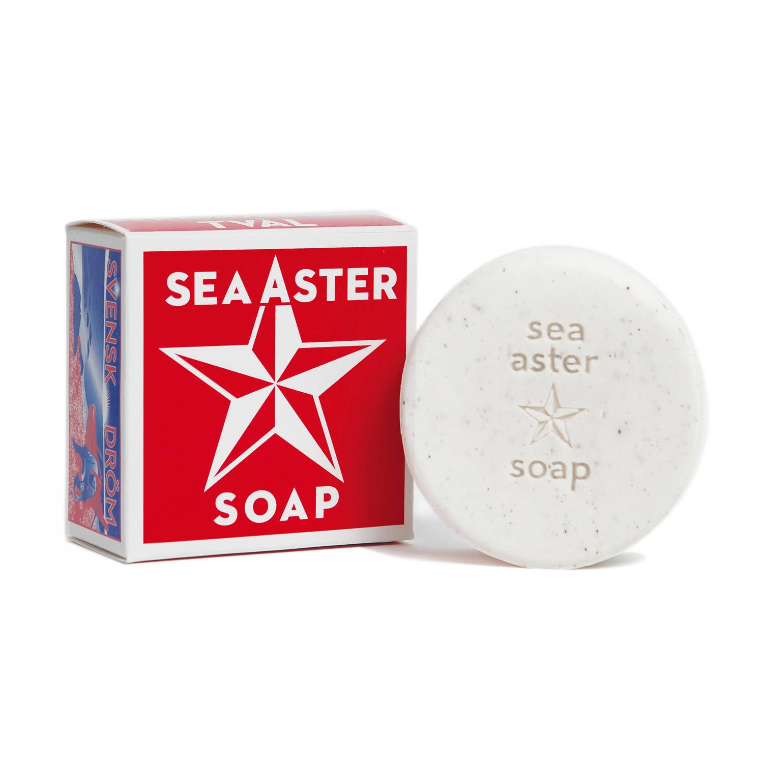 A round bar of Swedish Dream Sea Aster soap with soothing exfoliating speckles sits beside a red box labeled "Swedish Dream Sea Aster Soap," adorned with a calming star design.