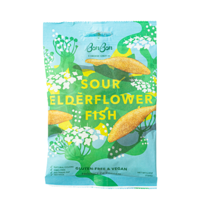 A blue and green bag of BonBon - Sour Elderflower Fish Swedish Candy (150g) contains yellow fish-shaped gummies; the packaging highlights that its vegan and gluten-free.