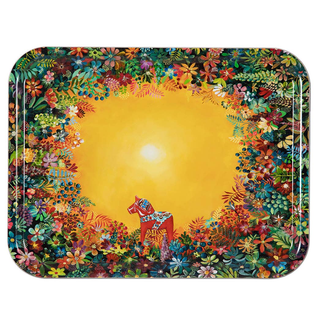 The "Tray: Light of Grytnäs Dala Horse" by Swedish artist Nadja Wedin (10.75 x 8 inches) is showcased at the center of a yellow clearing, surrounded by vibrant flowers and lush foliage.
