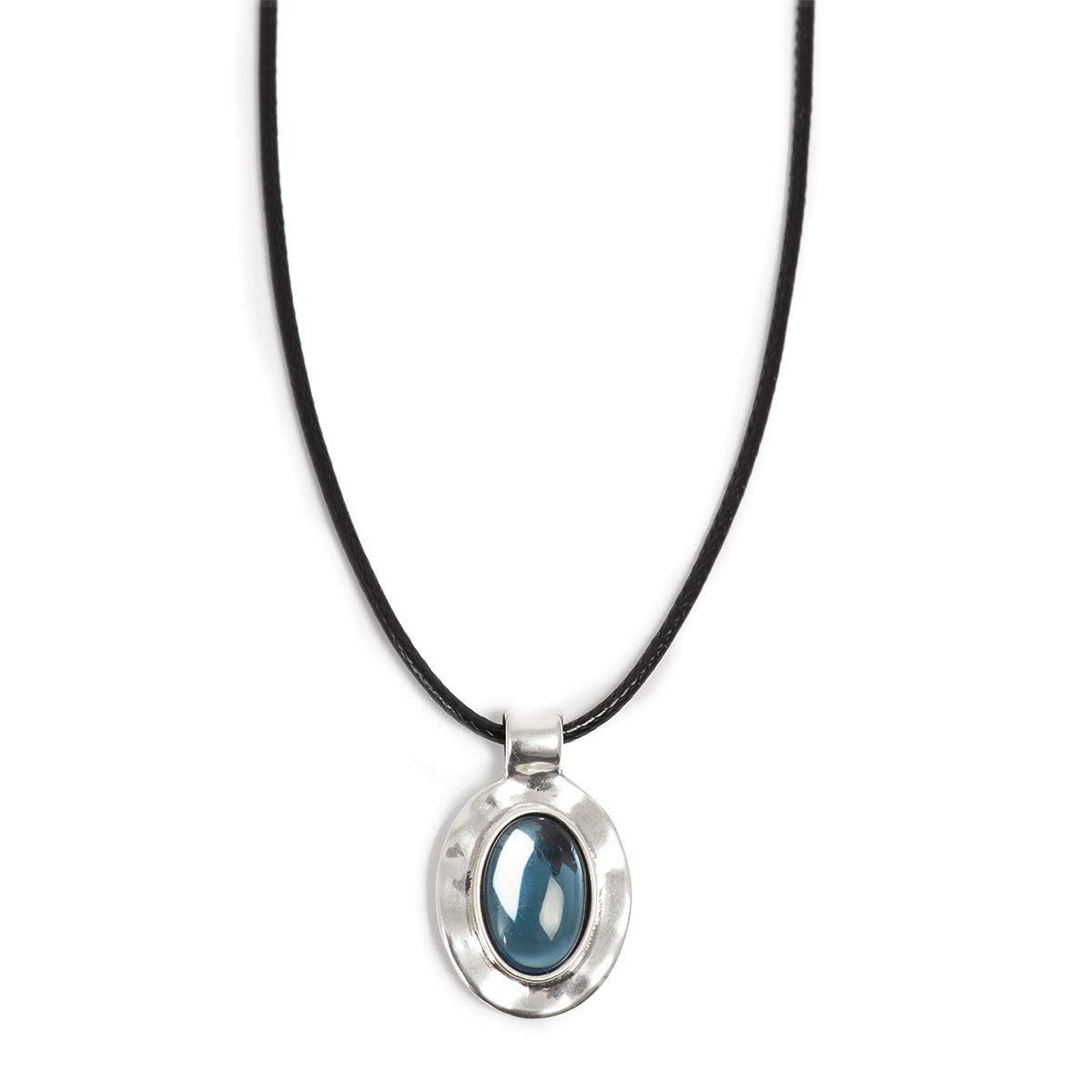 The A&C Oslo Silver Deep Blue Glass Necklace features a glossy deep blue glass stone set in a silver oval pendant on a black cord.