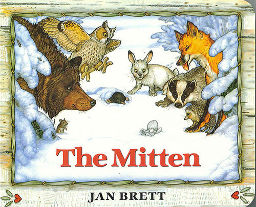 Illustrated board book cover of Mitten by Jan Brett, inspired by a Ukrainian folk tale, with animals like a bear, owl, rabbit, fox, badger, and a cozy mitten in the snow.
