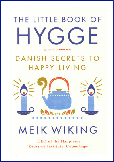 Cover of the book Little Book of Hygge: Danish Secrets to Happy Living, by Meik Wiking, adorned with a cozy teapot illustration and two flickering candles. Immerse yourself in the Danish philosophy for cultivating happiness and warmth in everyday moments.