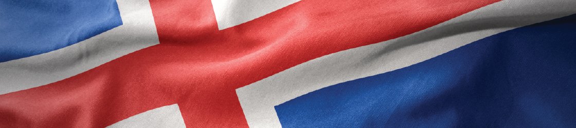 Close-up of the Icelandic flag waving, featuring a blue field with a white-fimbriated red Nordic cross.