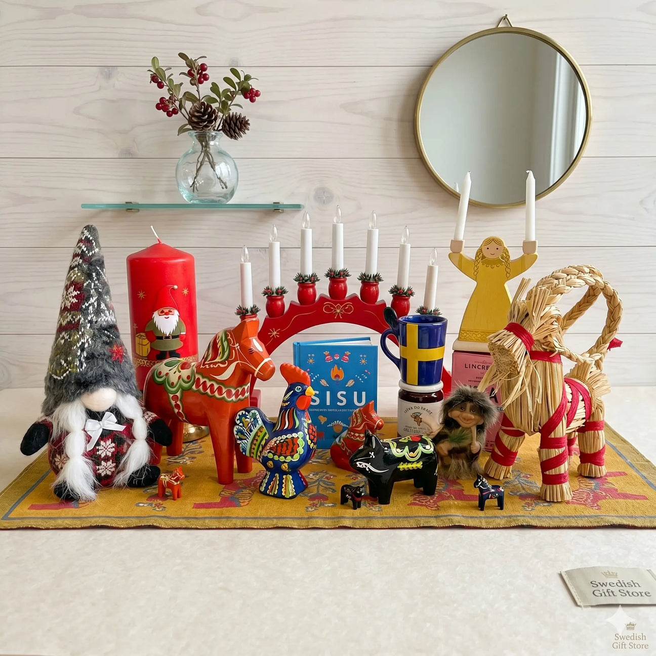 A store display with various home decor items, including candles, mugs, textiles, and ornaments on shelves and tables.