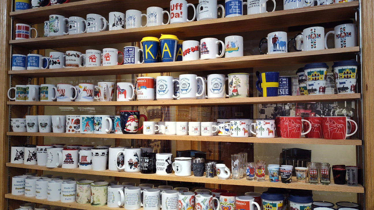 Shelves filled with a variety of collectible mugs and cups, each displaying different designs, colors, and patterns.