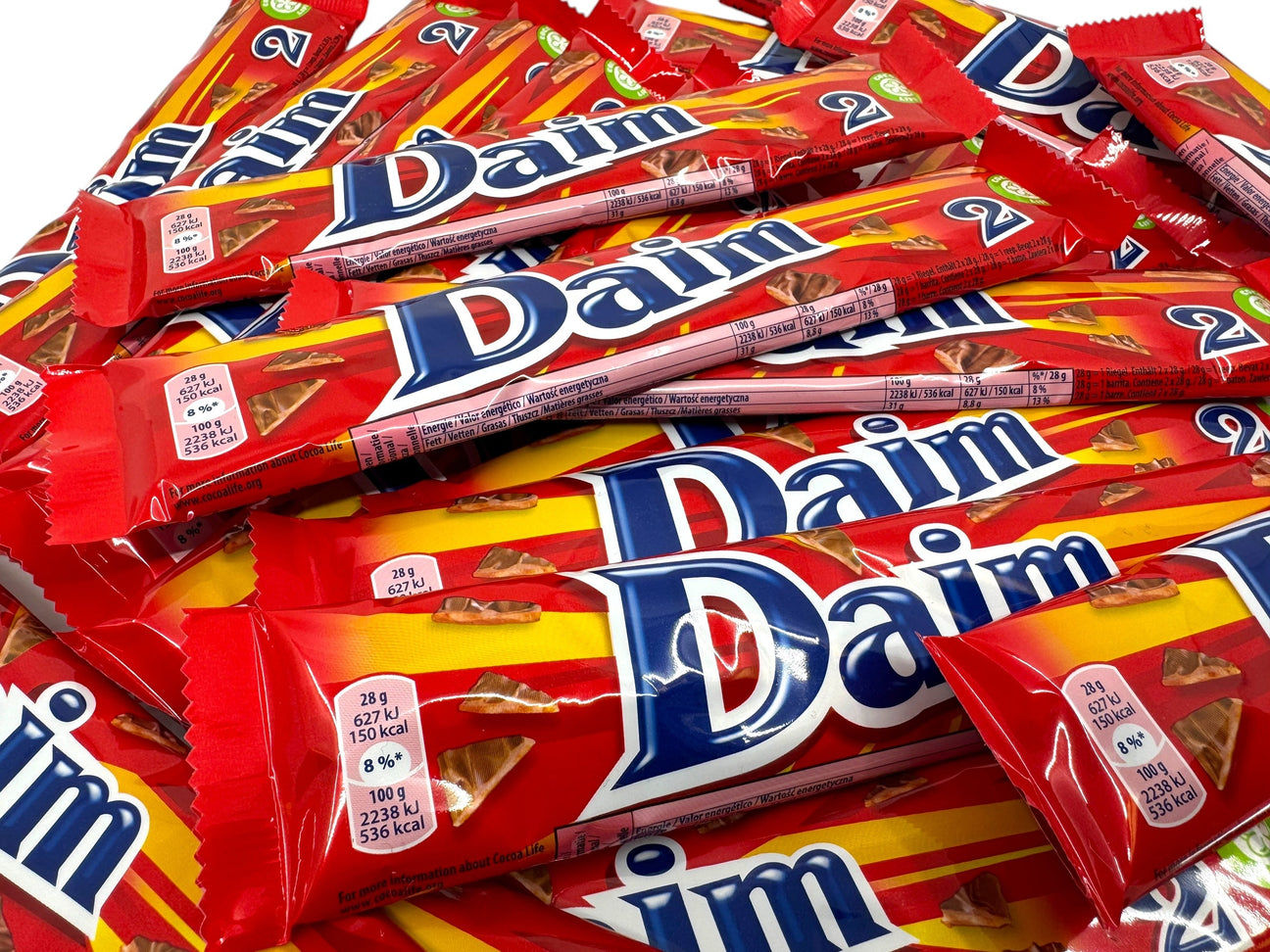 A pile of red-packaged Daim chocolate bars, each displaying nutritional information.