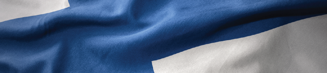 Close-up of the Finnish flag with a blue cross on a white background, gently waving.