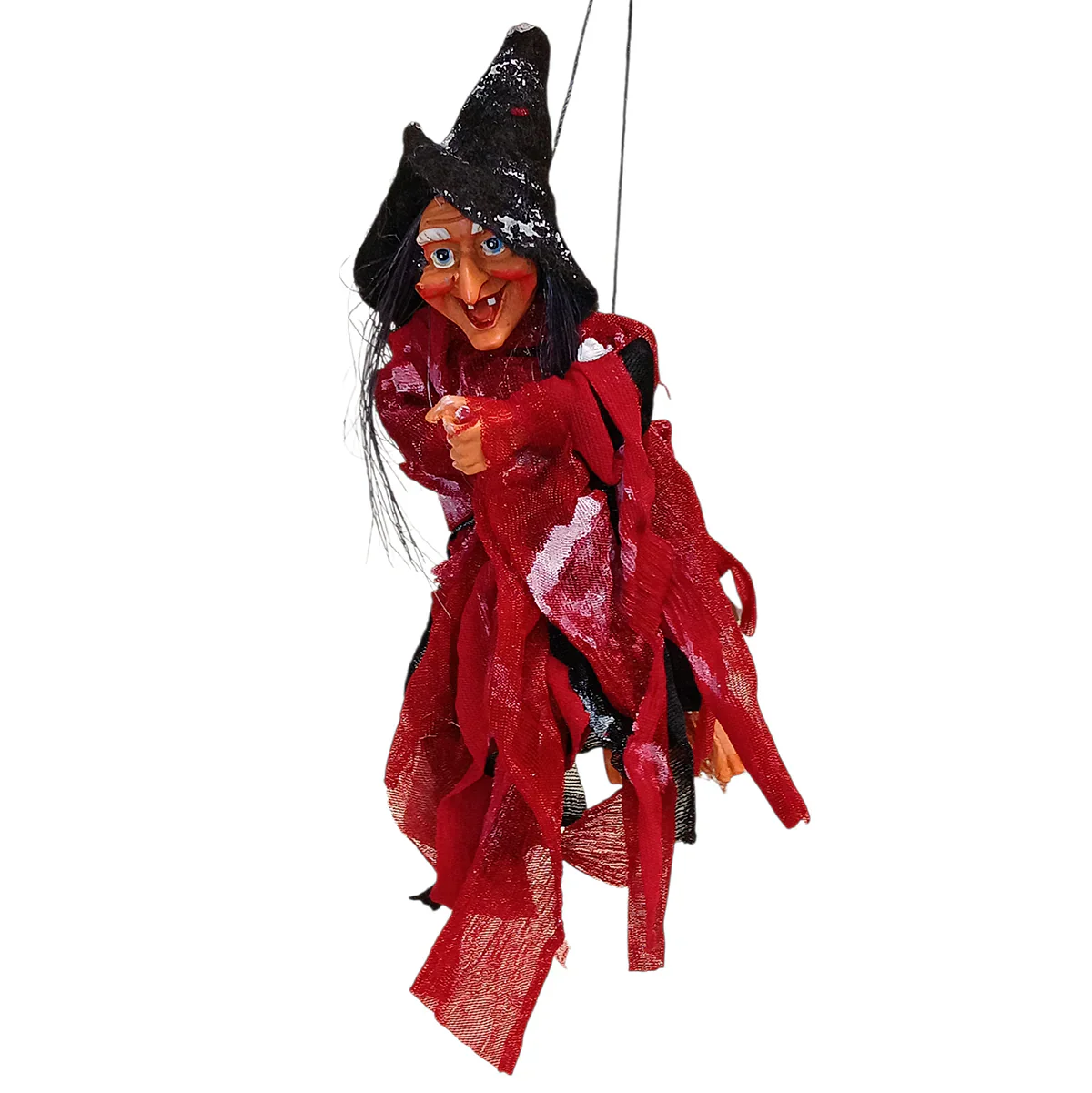 A marionette witch puppet with a pointed black hat, red and black ragged clothing, and exaggerated facial features is hanging on strings.