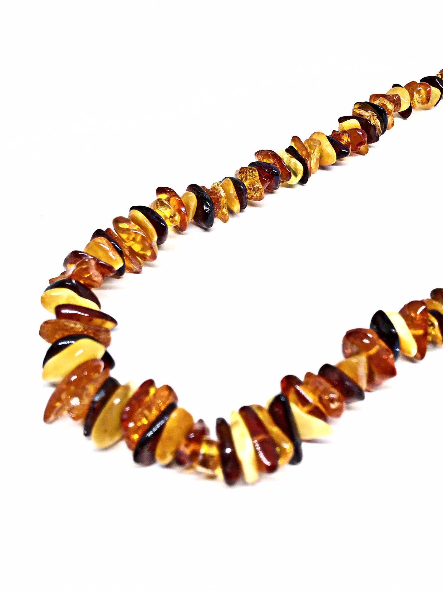 The 18 Multi-Color Amber Chip Necklace features stunning Baltic amber beads in honey and brown shades, elegantly arranged on a white background.