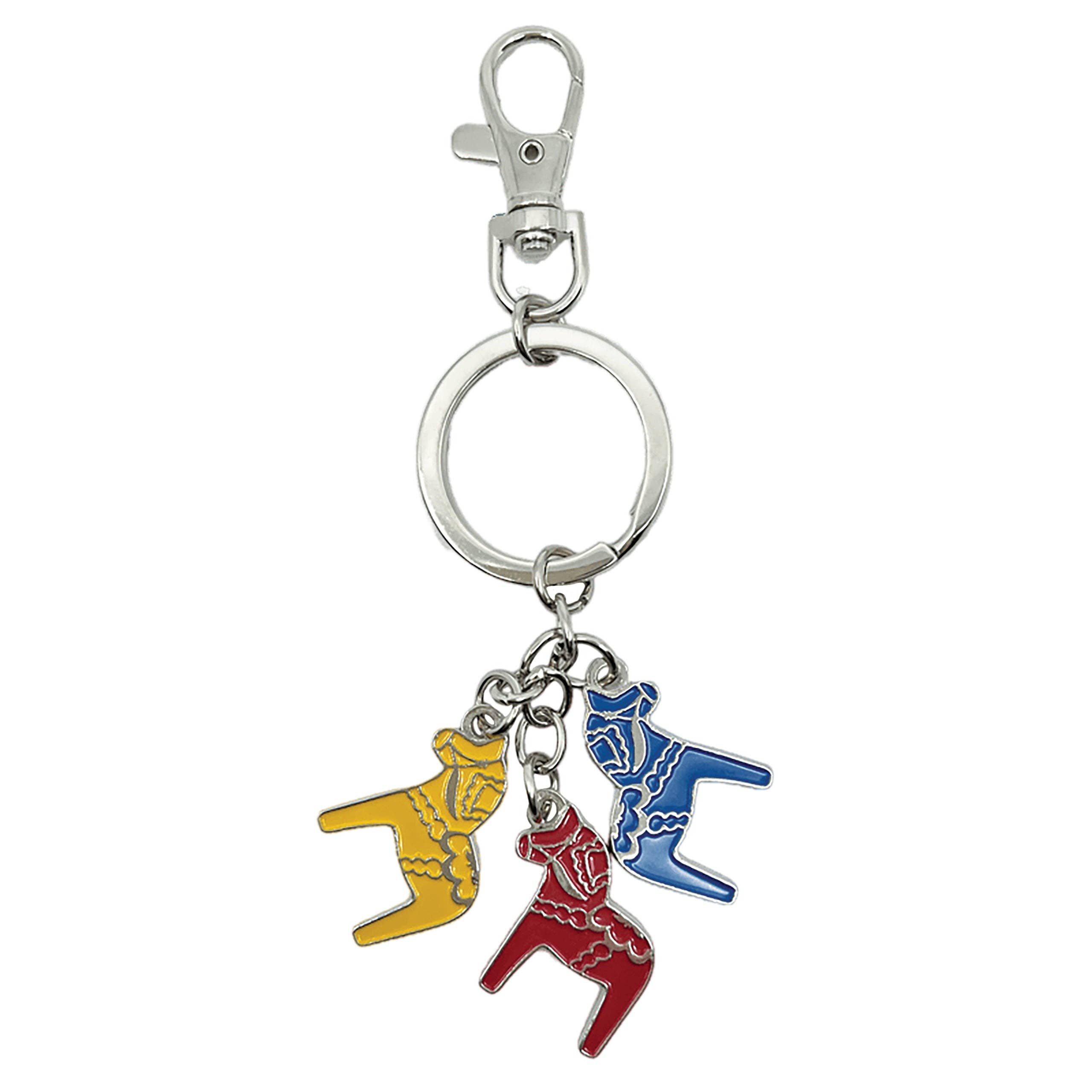 This collectible keychain has a silver clasp and three enamel charms shaped like vibrant red, blue, and yellow Swedish Dala horses.