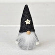 Scandinavian gnome figurine with a grey felt hat, wooden star, round wooden nose, and long white beard.