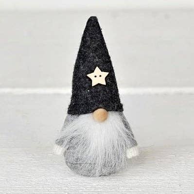 Scandinavian gnome figurine with a grey felt hat, wooden star, round wooden nose, and long white beard.