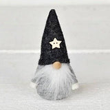 Scandinavian gnome figurine with a grey felt hat, wooden star, round wooden nose, and long white beard.