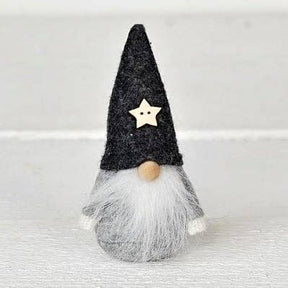 Scandinavian gnome figurine with a grey felt hat, wooden star, round wooden nose, and long white beard.