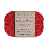 Red oval soap lift made of textured bioplastic with a brown label displaying printed text in multiple lines.
