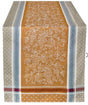Cotton table runner with a mustard-yellow center featuring white grapevines, flanked by beige and blue geometric borders.
