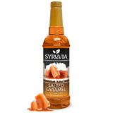 A bottle of Syruvia Syurp: Salted Caramel Syrup Pure Cane Sugar is shown with caramel pieces in front, set against a white background.