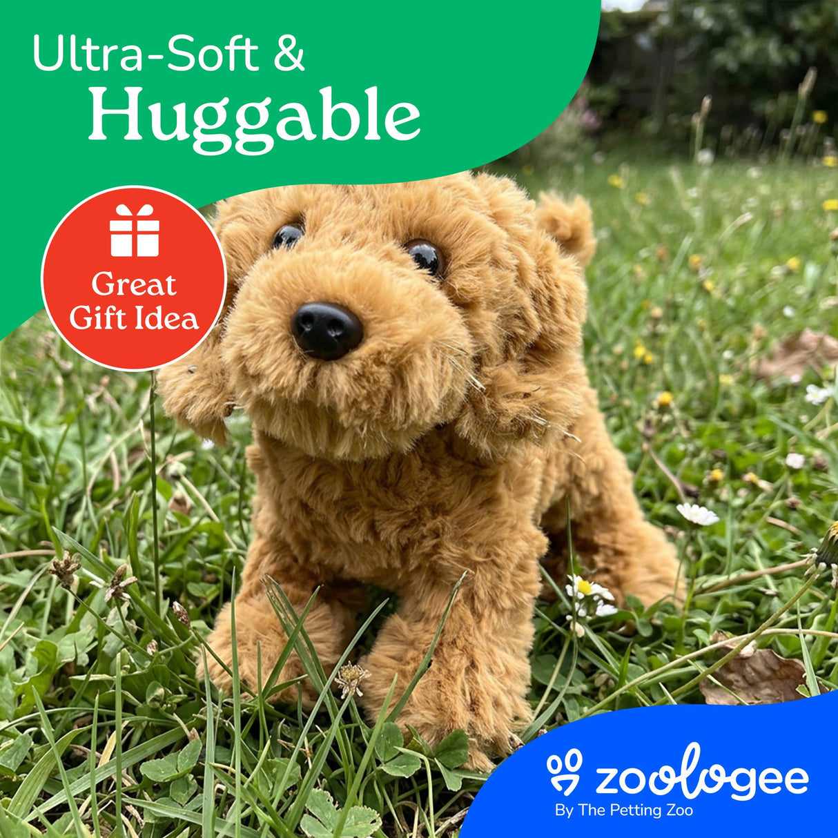 Brown Golden Doodle plush toy on green grass with white flowers, product tags reading Ultra-Soft & Huggable and Great Gift Idea, Zoologee logo in the corner.