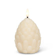 The Candle: Pinecone Flameless LED Candle - Ivory (4"H) is a battery-operated candle with textured pinecone details, offering a warm glow without an open flame.
