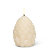 The Candle: Pinecone Flameless LED Candle - Ivory (4"H) is a battery-operated candle with textured pinecone details, offering a warm glow without an open flame.