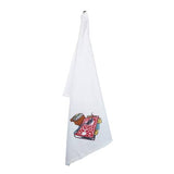 A white Scandinavian tea towel, the "Guide Book Tea Towel Betty Crocker Recipes," hangs on a hook with a small embroidered recipe book design near the bottom corner.