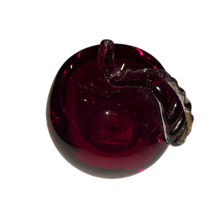 A 3-inch-tall, mouth blown Red Apple from Mantorp Glass, Sweden, with a curved stem and rich dark red color, shown against a white background.
