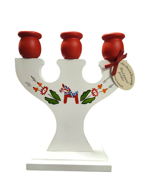 Hand crafted Swedish candle holder with Dala horse and kurbits design. Holds 3 candles in red holders with floral patterns, finished with a tag tied with a red ribbon.