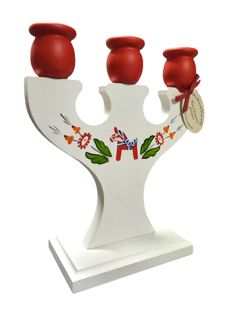 Hand crafted Swedish wooden candle holder with three red cups, hand painted kurbits designs and a blue Dala horse on the front. Includes an attached tag. Holds 3 candles.