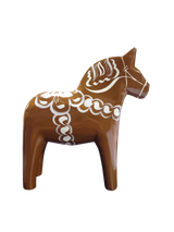 The Dala Horse: Swedish Dala Horse Brown with White Kurbits is a handcrafted Swedish pine figurine, painted brown with white kurbits patterns, shown in profile against a plain white background.