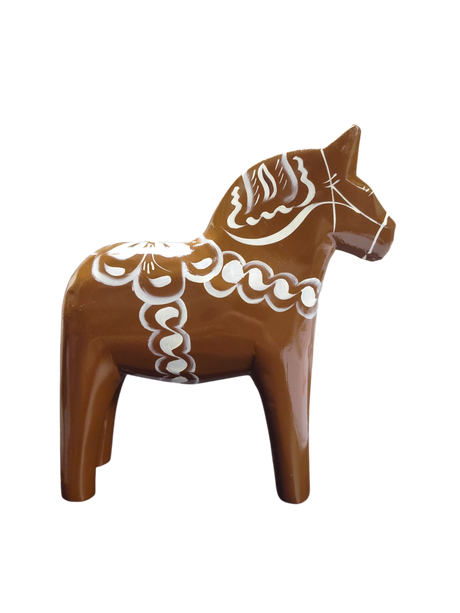 The Dala Horse: Swedish Dala Horse Brown with White Kurbits is a handcrafted Swedish pine figurine, painted brown with white kurbits patterns, shown in profile against a plain white background.