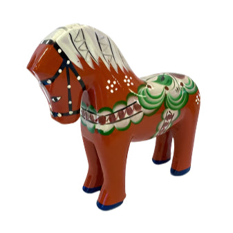 The Dala Horse: Färnäshästen Red by Nils Olsson (14 cm) is a hand-carved Swedish classic, painted in red with white, green, and blue patterns—an iconic piece of Scandinavian design.