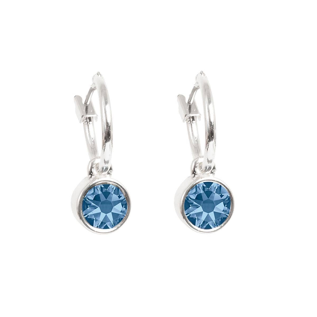 These stunning hoop silver earrings are designed with Denim Blue gemstones that shimmer like a calm sea.