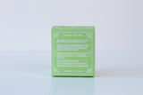 A small green box with white patterns and instructions on one side displays the Soap: Coconut Island Bath Bomb—a handmade, skin-nourishing bath bomb—set against a plain white background.