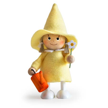 The Figurine: Scandinavian Girl in Yellow with a Watering Can is handcrafted, showcasing a person in yellow attire with an orange watering can and flower, perfect as a charming gardening gift.