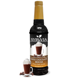 A 750 ml bottle of Syruvia Swiss Chocolate Mocha Syrup with Pure Cane Sugar is beside a glass of chocolate mocha topped with whipped cream and chocolate curls; this gluten-free syrup adds indulgence to drinks.