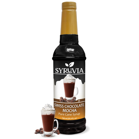 A 750 ml bottle of Syruvia Swiss Chocolate Mocha Syrup with Pure Cane Sugar is beside a glass of chocolate mocha topped with whipped cream and chocolate curls; this gluten-free syrup adds indulgence to drinks.