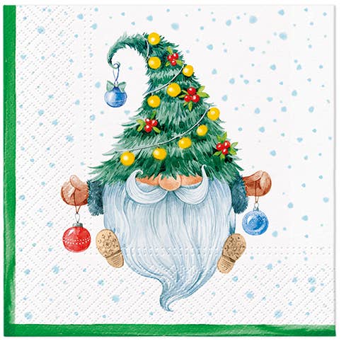 A gnome with a long white beard and a Christmas tree hat with ornaments sits on a snowy background—perfect for Napkins: Fancy Gnome Lunch Napkins - 20 pkg Christmas Paper Napkins.