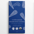 Blue wrapper with text: “Sted Cardamom Krumkake Cookie, 50% dark milk chocolate,” visible Scandinavian mention; symbols for organic, soy-free, gluten-free, palm oil–free.