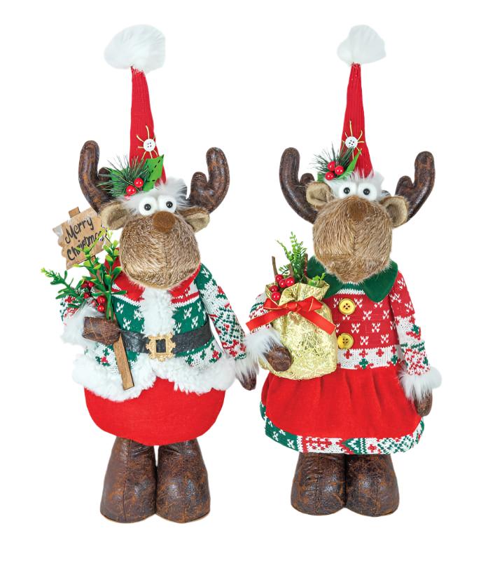 A pair of Mr. and Mrs. Winter Kisses Moose Stander plush toys, dressed festively for Christmas, cheerfully serve as Merry Christmas greeters. One displays a "Merry Christmas" sign with pride, while both hold charming holiday bags brimming with seasonal decorations.