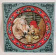 The 6" ceramic tile, "Fjord Horse with Tomte," shows a gnome in red sitting with a horse by candlelight in a stable, framed by rosemaling art—perfect Scandinavian holiday décor. Cork backing included.